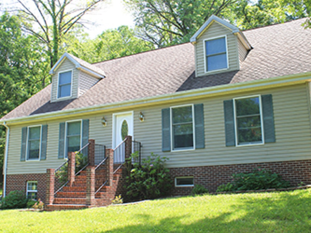 a brick house with grass in front