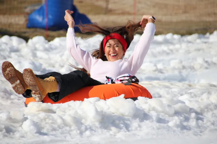 a person riding on top of a pile of snow