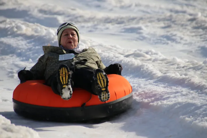 a little boy that is standing in the snow