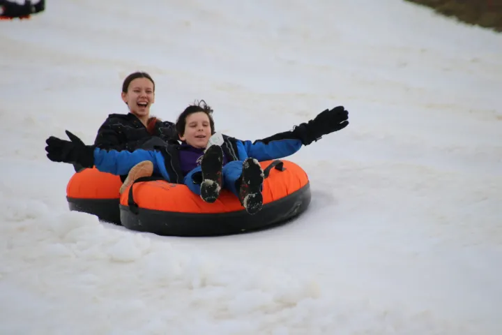 a little boy that is sitting in the snow