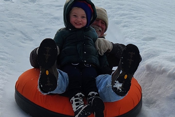 a little boy that is sitting in the snow